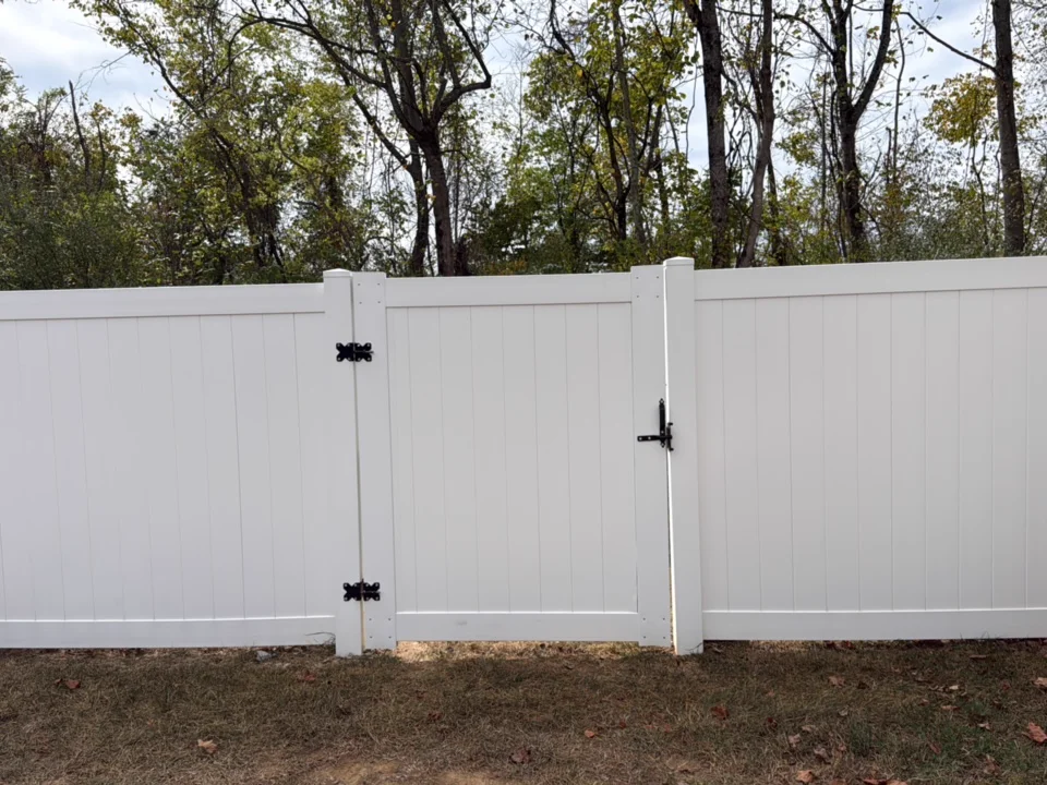 Green algae washed off a white vinyl fence — after professional cleaning in Spring Hill, TN