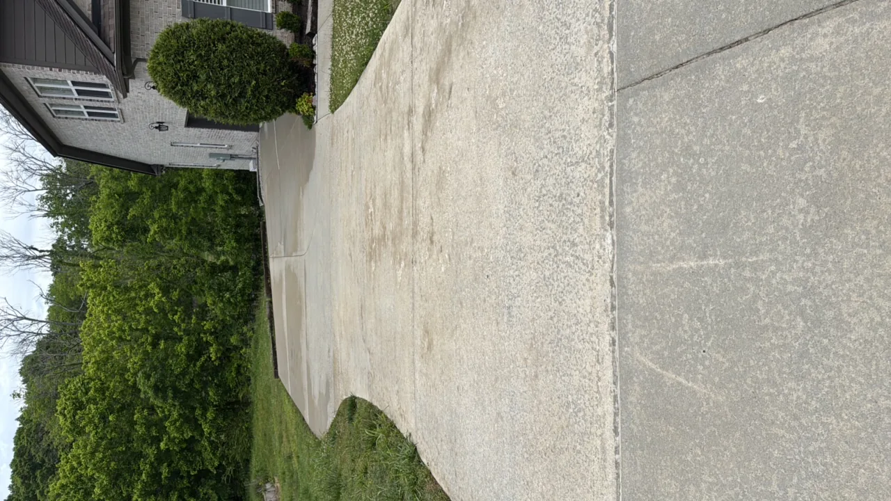 Concrete driveway cleaned and sealed — before cleaning in Franklin, TN